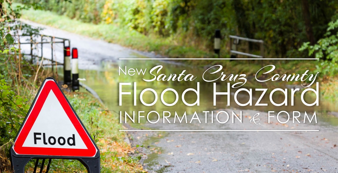 flooded road with flood hazard sign